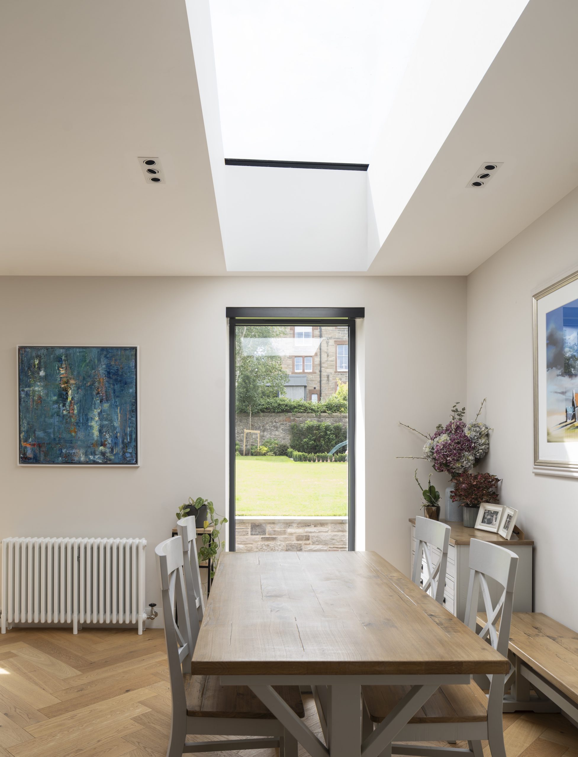 Dining with glazing and frameless rooflight