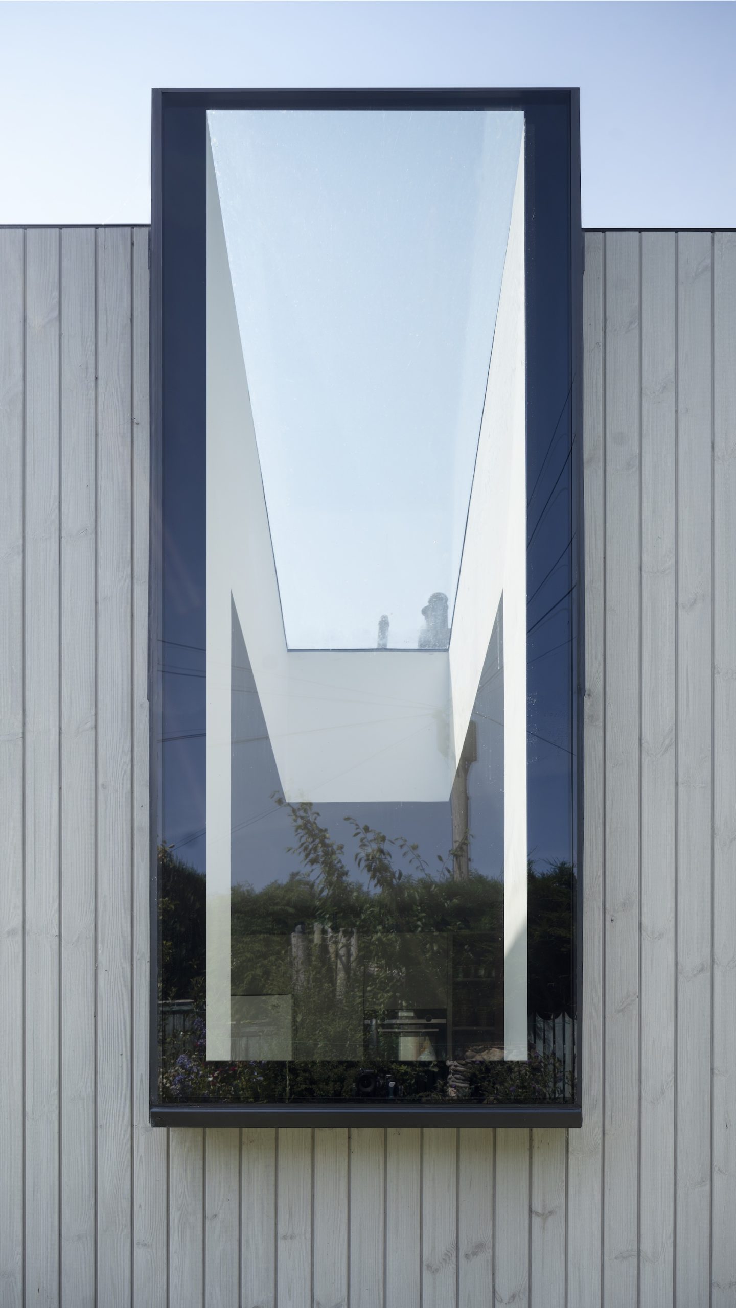 Timber clad extension with frameless window and rooflight
