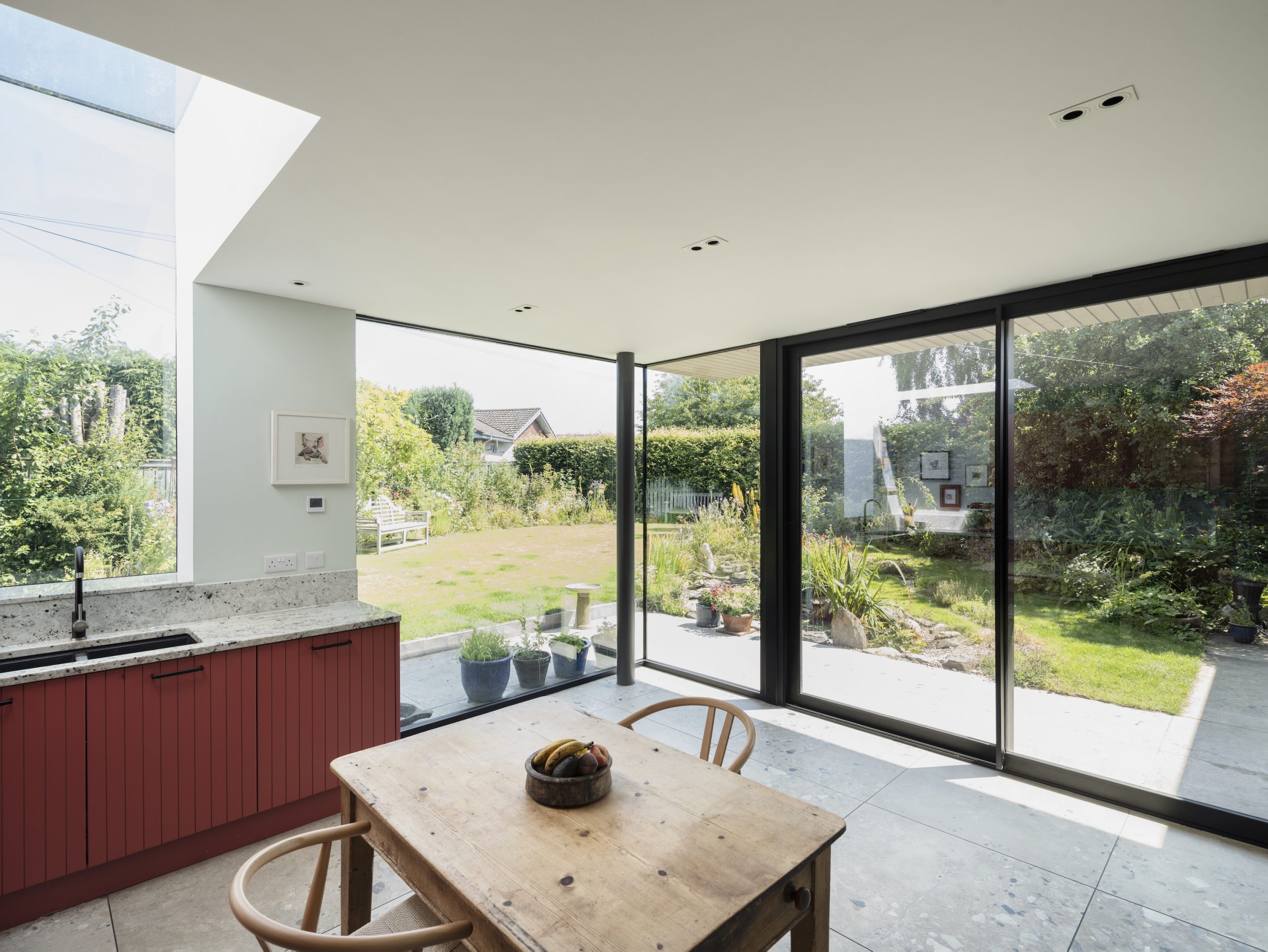 Extension with kitchen in Bamboozle by Farrow & Ball, frameless window & rooflight and frameless corner glazing