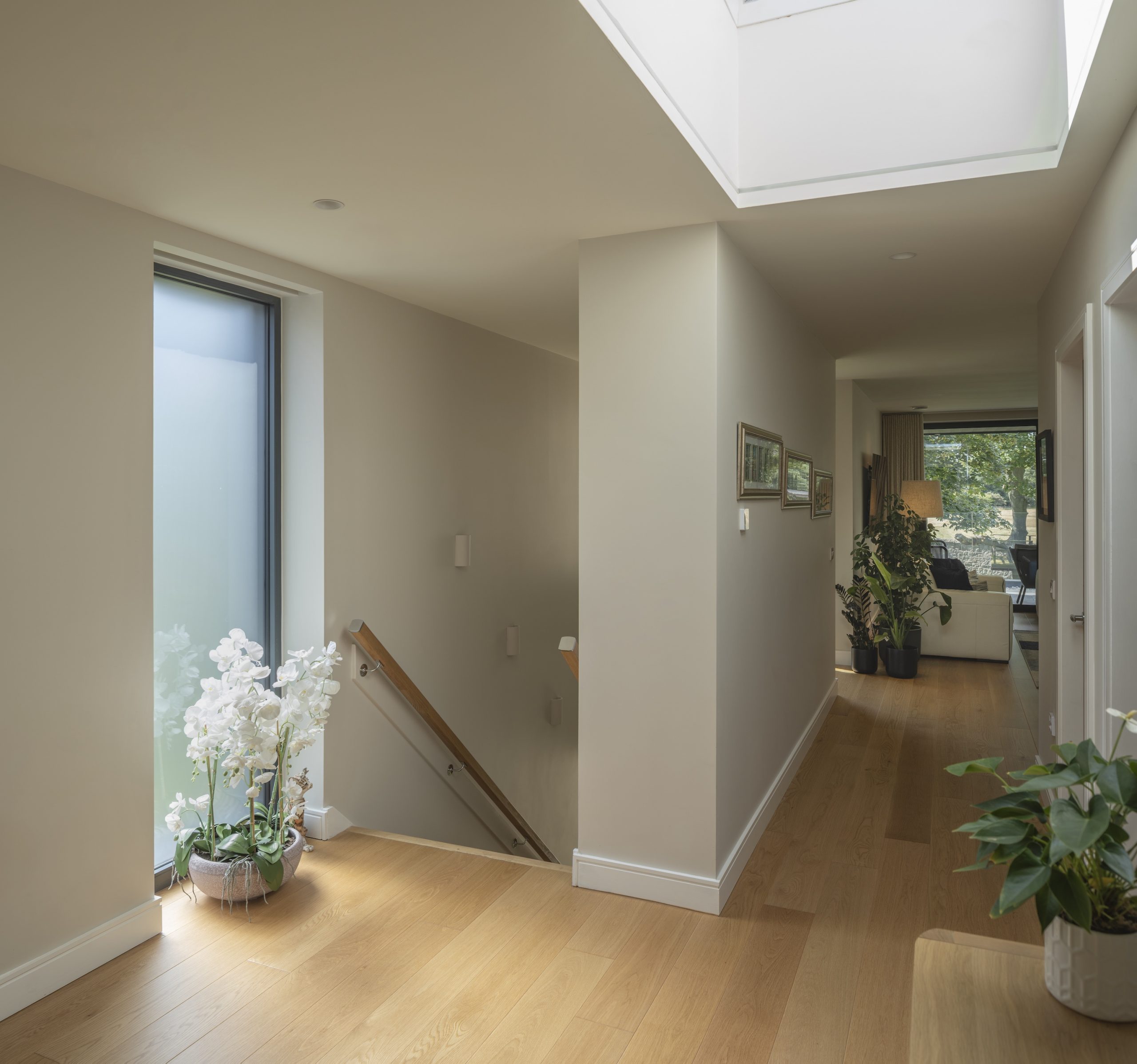 Stair landing with oak flooring and rooflight that opens towards drawing room