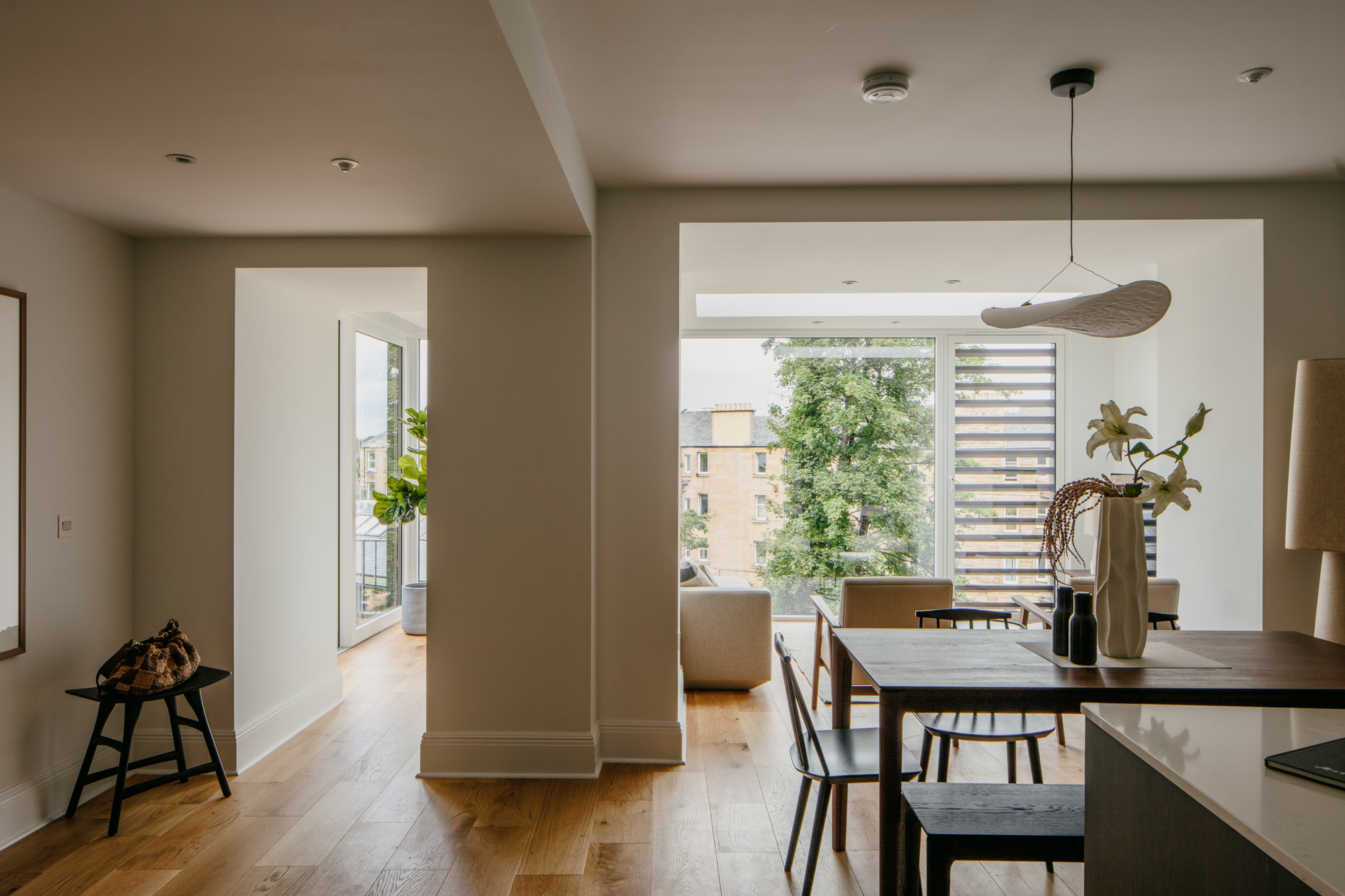 Contemporary interior with large format glazing, rooflight and louvred screen