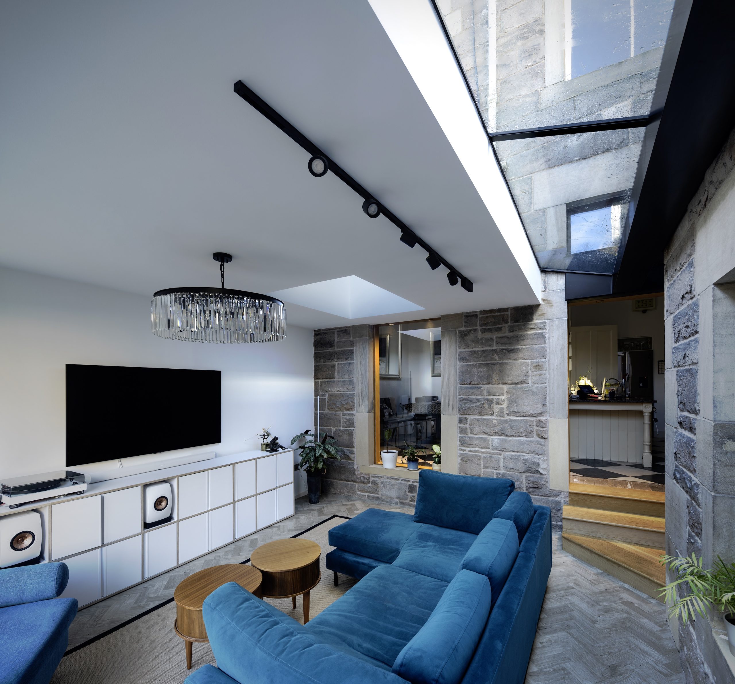 Contemporary extension with frameless rooflight and exposed stone walls